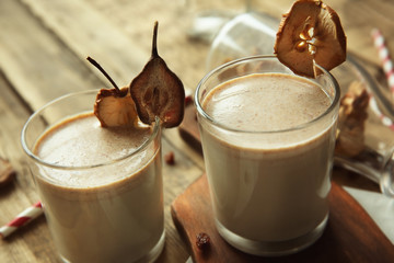 Milk shakes with dried fruits on wooden table