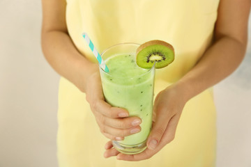 Woman holding kiwi milk shake