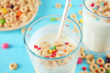 Milk shake with cereals on color background