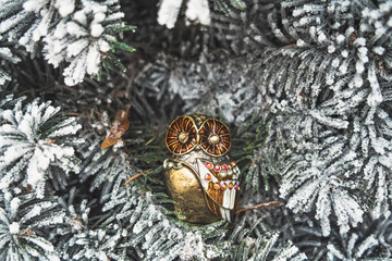Christmas toy owl on а fir-tree
