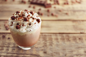 Delicious milk dessert with chocolate on wooden background