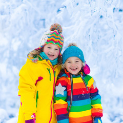 Kids play with snow in winter park