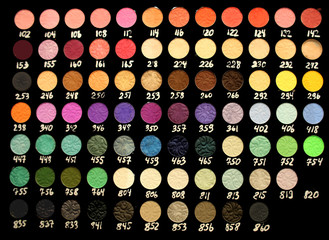 Fototapeta na wymiar Assortment of different colourful eye shadow palettes in cosmetic store