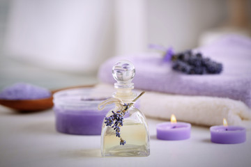 Obraz na płótnie Canvas Bottle with lavender essential oil on table