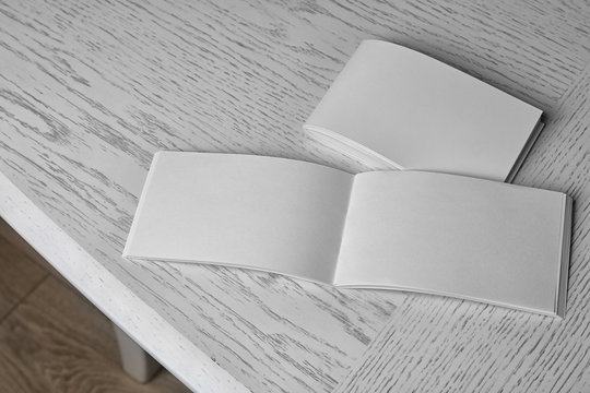 Blank brochures on wooden table