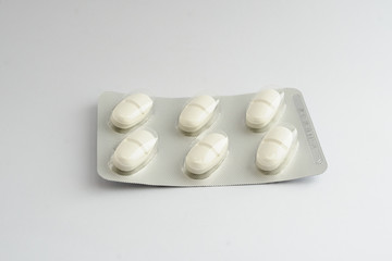 white pills tablets in a blister drugs