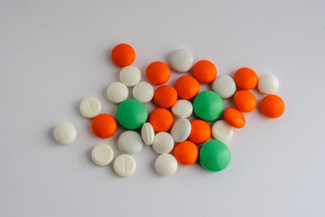 white pills green dragees and orange

