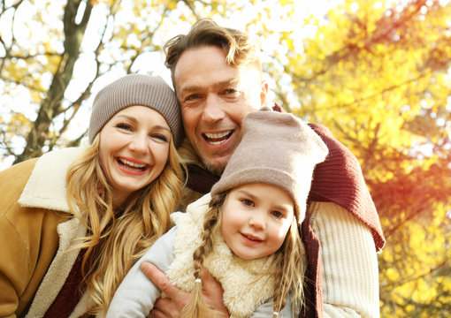 Happy family playing in beautiful autumn park