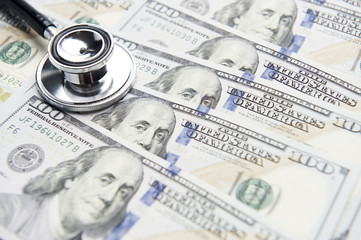 Stethoscope on a stack of money