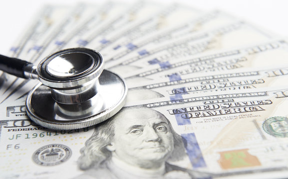 Stethoscope on a stack of money