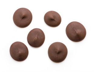 Dark chocolate chips isolated on white background. Top view.
