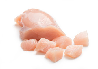 Raw chicken fillet. Small pieces of meat isolated on white.