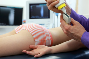 doctor applying gel on head of ultrasound - examination,close up