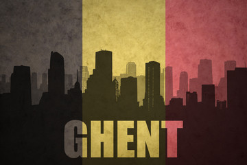 abstract silhouette of the city with text Ghent at the vintage belgian flag