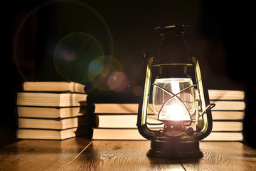 The light of kerosene lamp and books on the table