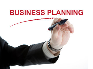 businessman hand writes an inscription business plan