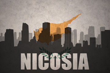abstract silhouette of the city with text Nicosia at the vintage cyprus flag