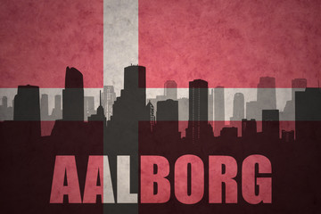 abstract silhouette of the city with text Aalborg at the vintage danish flag