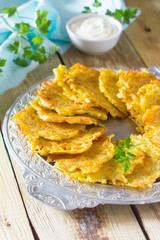 Homemade traditional potato pancakes, served with sour cream sau