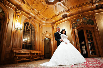 Awesome wedding couple indoor rich royal room with classic woode