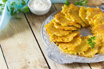Homemade traditional potato pancakes, served with sour cream sau