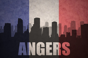 abstract silhouette of the city with text Angers at the vintage french flag
