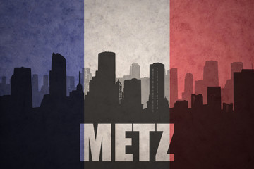 abstract silhouette of the city with text Metz at the vintage french flag