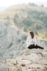 Fototapeta na wymiar woman with backpack standing on a rock