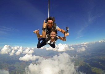 Skydiving tandem couple happy - 127847319