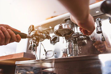 barista shows how coffee machine works