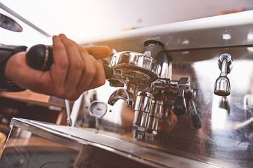 barman holding a coffee making equipment