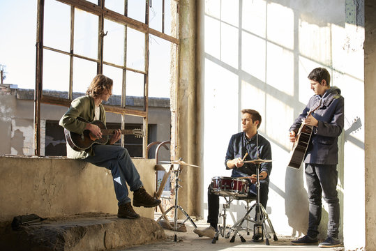 Ready for entertain. Full length shot of a rock band practicing to playing music.