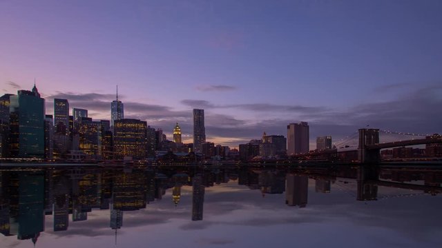Time lapse of Manhattan, New York with a mirror image in the foreground.