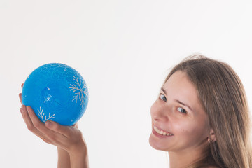 woman's hands holding a blue Christmas Christmas ball on a white background 