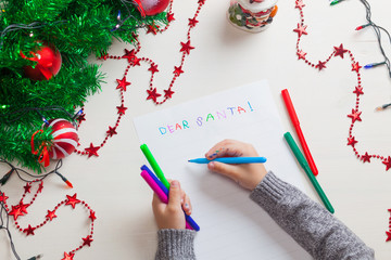 Children writing letter to Santa Claus at Christmas.