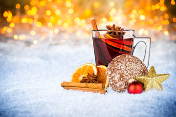 hot spiced wine on christmas xmas market  snow bokeh background with many lights ice blue  snow 