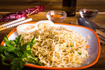 noodles with boiled egg on a wooden background