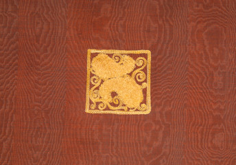 background of the fabric material and the red and burgundy textiles square gold pattern