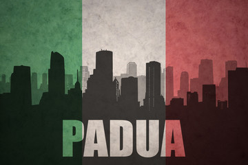 abstract silhouette of the city with text Padua at the vintage italian flag