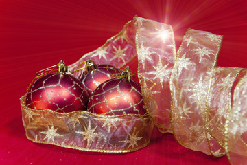 New Year's composition on a red background - ball and ribbon