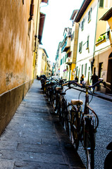 Fototapeta premium Row of bycles parked on an urban street