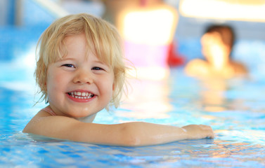 Fototapeta na wymiar Happy young girl in swimming pool