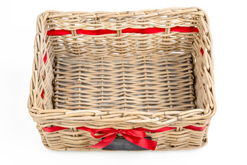 Woven rectangle box,basket with red satin ribbon (tape) and small blackboard. Vintage Christmas decoration box for Christmas and new year, isolated on the white background. Empty basket. Top view