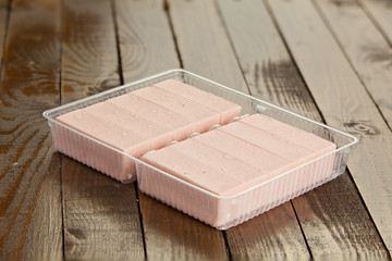 Delicious  strawberry paste  on plate on wooden