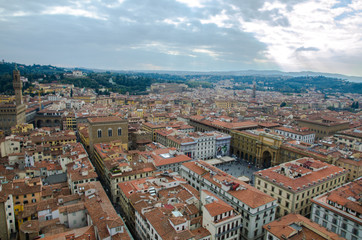 Fototapeta na wymiar The tuscan red rooftops of Florence with a square in the middle