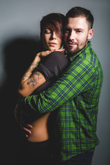 Beautiful couple hugging and laughing on the tein background. The concept of fun, love and happiness