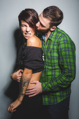 Beautiful couple hugging and laughing on the tein background. The concept of fun, love and happiness