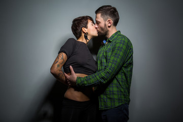 Handsome couple gently kissing on the tein background. The concept of passion, love and tenderness