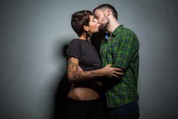 Handsome couple gently kissing on the tein background. The concept of passion, love and tenderness