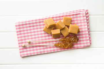 Brown sugar crystals on stick and caramel candies.